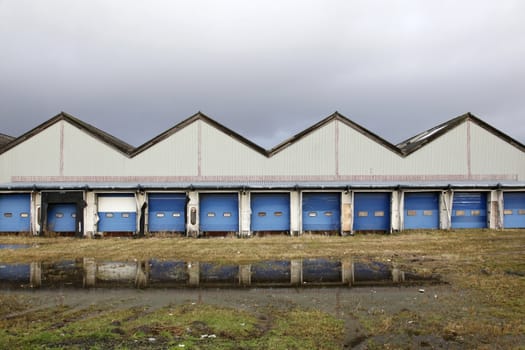 verlaten laadstation met gras en regenplassen