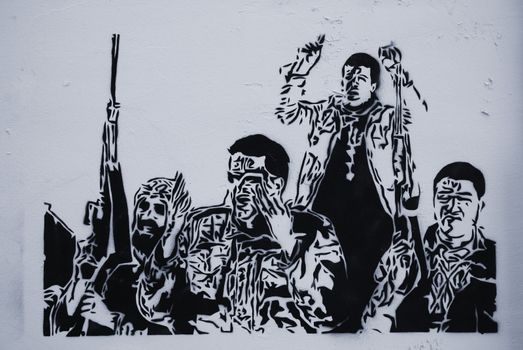 LEFT-WING GRAFFITI, PARIS, FRANCE - APRIL 21, 2011: Anarchist stencil graffiti on Montmartre wall. Monochrome image.