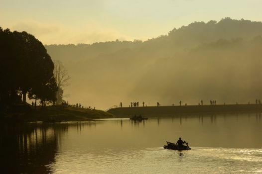 Silhouette of  tourist  on raft at Pang Ung lake, Maehongson Province,  North of Thailand