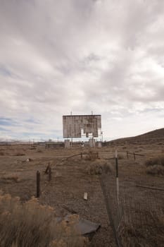 abandoned movie theater int he desert with clouds