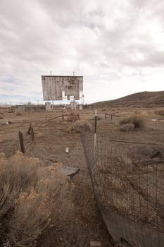 abandoned movie theater int he desert with clouds
