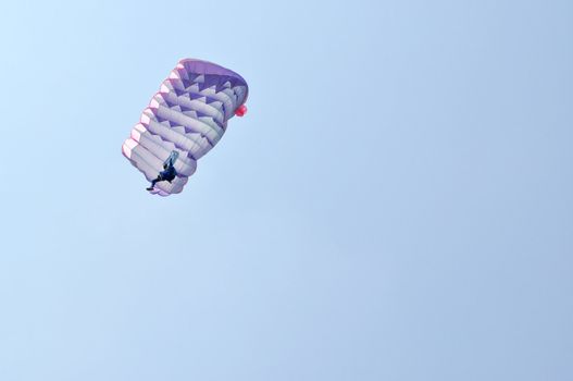 A parachute over a blue sky background