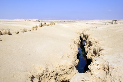 Earth fracture with sea water in egyptian desert.