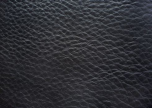 Black leather close up photography as background.