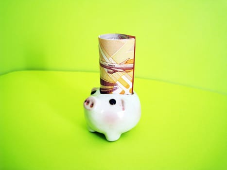 a piggy ornament with money, metaphors for banking, finance