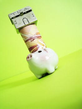 a house on top of money and piggy, metaphors for banking, finance