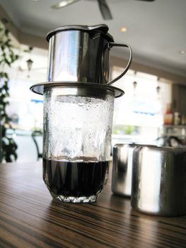 a fresh brewing coffee in a glass.