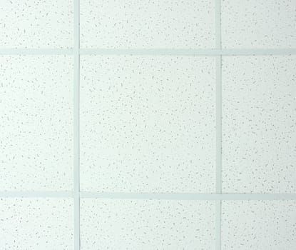 Hanging white  styrofoam tiled ceiling. Photo texture.