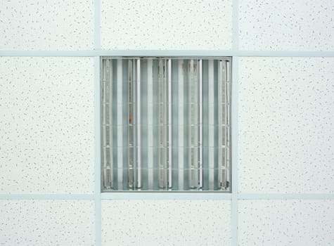 Hanging white  styrofoam tiled ceiling with lamp. Photo texture.