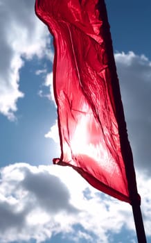 brightly red flag on winds, spring cool sky
