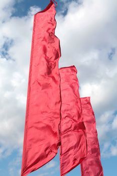 brightly red flags on winds, spring cool sky