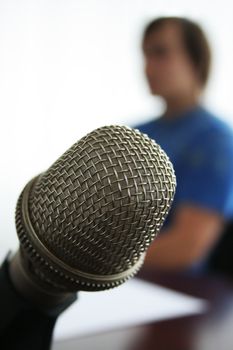 Microphone in the foreground in radio studio