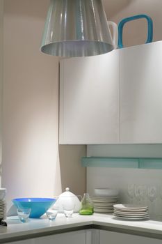 interior of modern kitchen in light tone with blue tureen