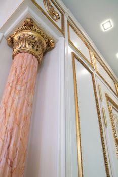 fragment of the luxurious interior with pillar of rose marble