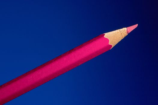 Pink pencil on a dark blue background