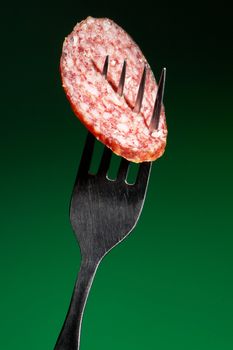 Piece of smoked sausage on a fork