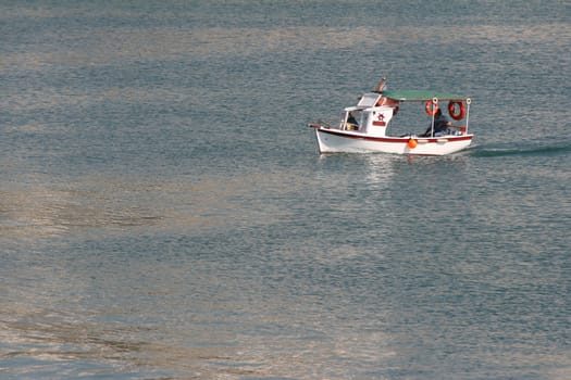 traditional wooden small boat sailing in the sea