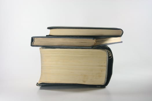 three old books closeup in white background profile