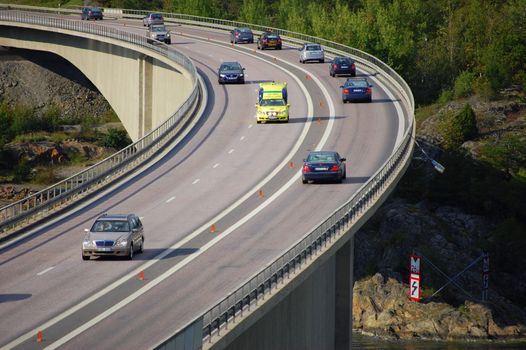 An ambulance going fast on a bridge