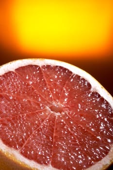Half of grapefruit on a yellow background