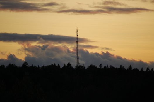 A telecommunication mast at sunset.