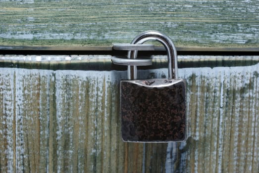 Padlock and closed painted old style box. Can be used as background or backdrop. Conceptual.