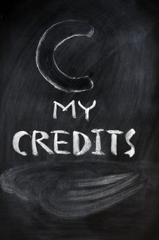 Credits sign written with chalk on a blackboard