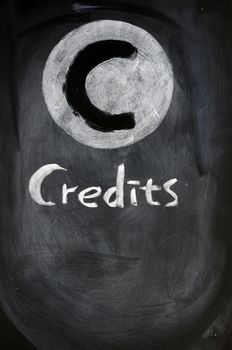 Credits sign written with chalk on a blackboard