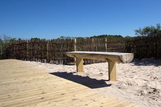 Lonely empty bench in the beach dunes