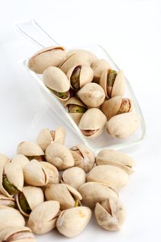 Close-up roasted and salted pistachios on white plate