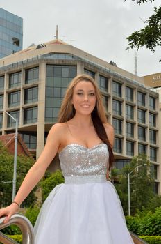 Young ballet dancer with city buildings in the background.