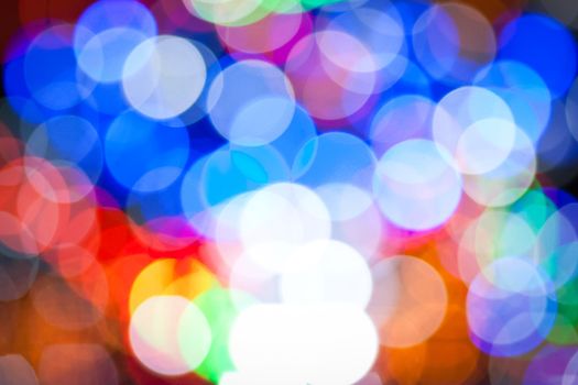 Christmas background with blurred dots in red, blue and golden colours