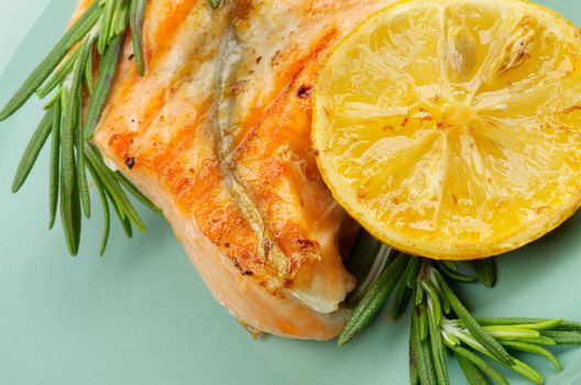 Fillet of Grilled Salmon with Rosemary and Lemon closeup on Green Plate