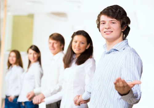 group of people holding hands, man holds out his hand, the concept of teamwork