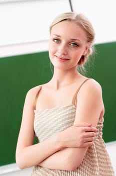 portrait of a beautiful female teacher, hugging her arms