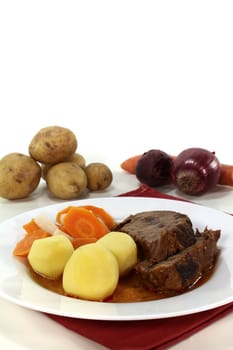 Slices of Roast beef with roast potatoes, carrots and gravy