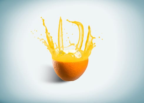 ice cubes fall into the orange, spray and splashes of juice