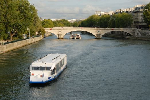 Seine river with tourists ships and cathedral Notre Dame in the background. Paris, France.