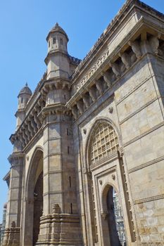 Vertical take of the Gateway of India with a defocused cameo view of the Taj Hotel from an angled view of an archway