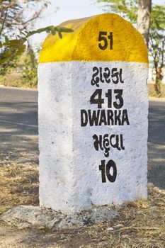 Portrait of the directional sign landmark and milestone on the Gujarat highway, India for Mahuva and Dwarka