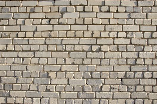 White brick wall. Abandoned architectural details backdrop.