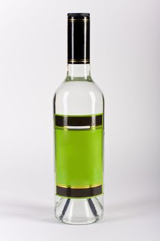 Bottle of vodka with green label on a white background.