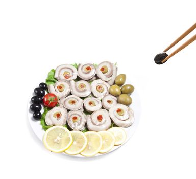 fish slices served with tomato and olives, and lemon