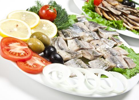 fish slices served with tomato and olives
