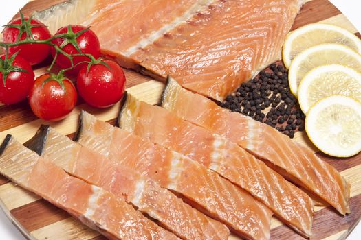 close-up of smoked salmon  with tomato and lemon