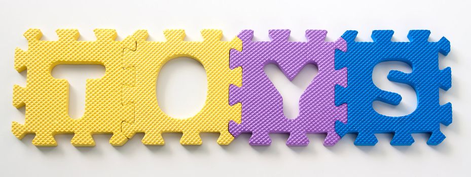 toys text made of puzzle letters isolated over white
