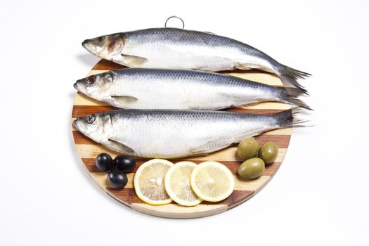 Fish with lemon and olive on plate