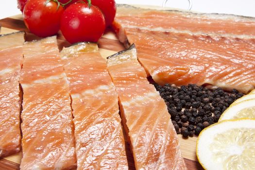 close-up of smoked salmon  with tomato and pepper