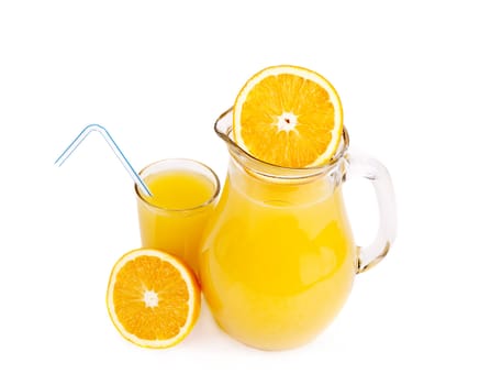 Orange juice in pitcher and oranges