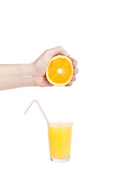 hand pour orange juice from orange